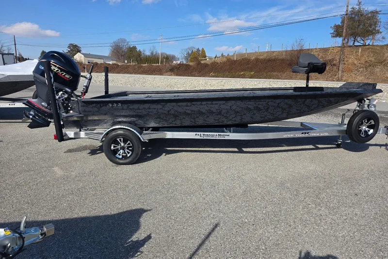 The Image of 2026 Xpress X18DB boat on trailer with Yamaha engine, parked outdoors. - 2