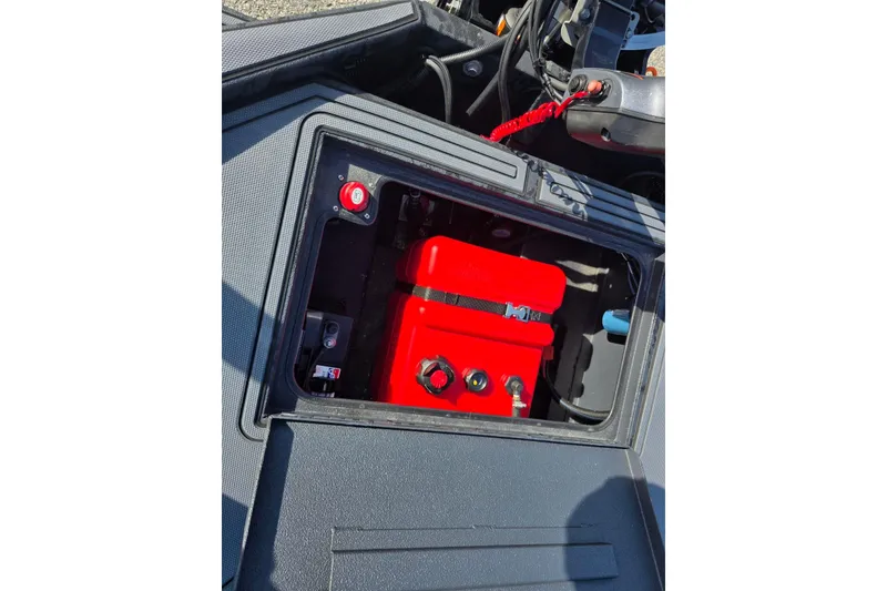 Slide: The Image of 2026 Xpress X18DB boat battery compartment with red battery and wiring. - 20