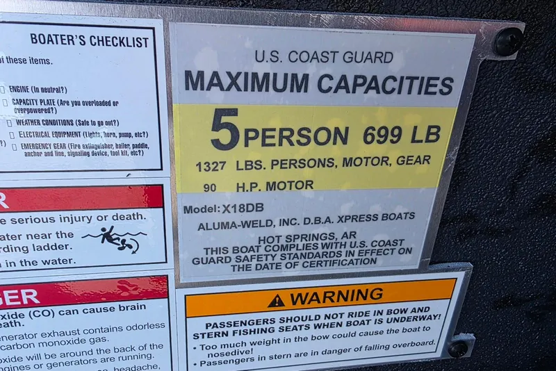 Slide: The Image of 2026 Xpress X18DB boat capacity label, 5 persons, 699 lbs, U.S. Coast Guard compliant. - 21