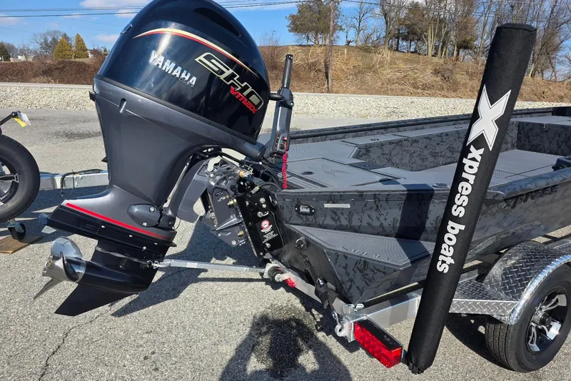 Slide: The Image of 2026 Xpress X18DB boat with Yamaha outboard engine on a trailer. - 6