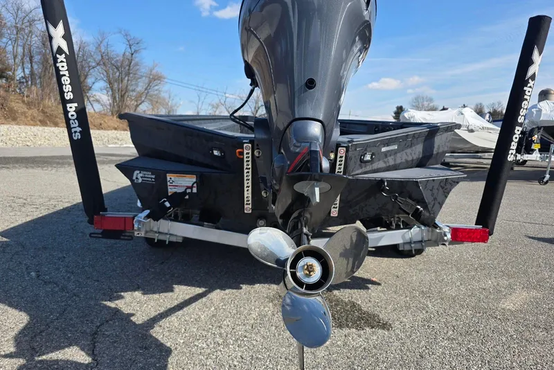 Slide: The Image of 2026 Xpress X18DB boat on trailer, rear view with motor and propeller. - 9
