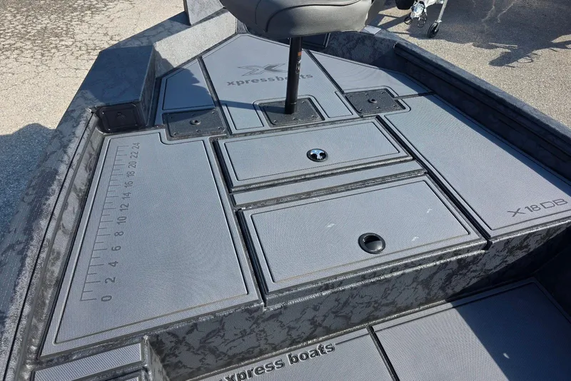 Slide: The Image of 2026 Xpress X18DB boat deck with storage compartments and measurement markings. - 11