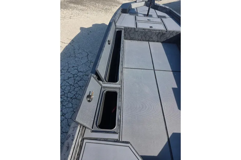 Slide: The Image of 2026 Xpress X18DB boat deck with open storage compartments, showcasing sleek design and functionality. - 17