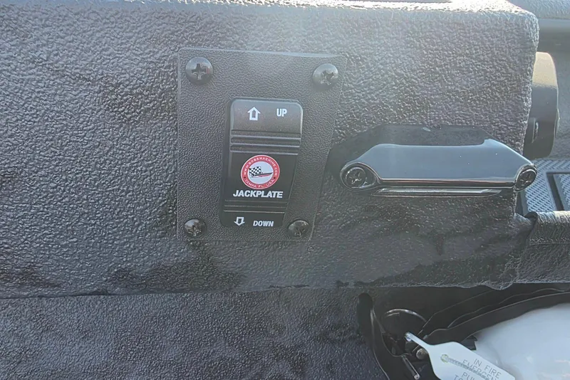 Slide: The Image of 2026 Xpress X18DB jackplate control panel with textured surface and switch for up and down adjustment. - 18