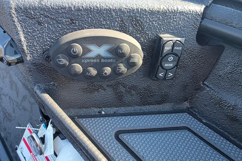 Slide: The Image of Control panel of 2026 Xpress X18DB boat with buttons and textured surface. - 19