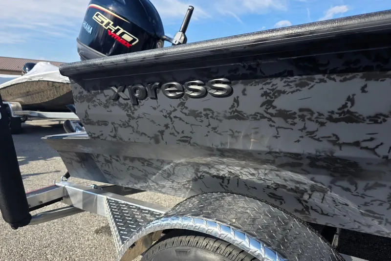 Slide: The Image of 2026 Xpress X18DB boat with Yamaha engine, featuring a sleek, patterned exterior design. - 5