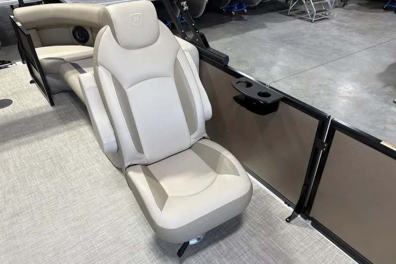 Slide: The Image of Luxurious seating on 2026 Premier 220 Sunscape RF boat, featuring beige upholstery and cup holders. - 11