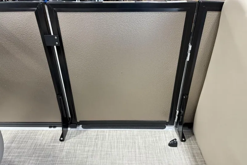 Slide: The Image of 2026 Premier 220 Sunscape RF interior gate detail with sleek black frame and beige panel. - 12