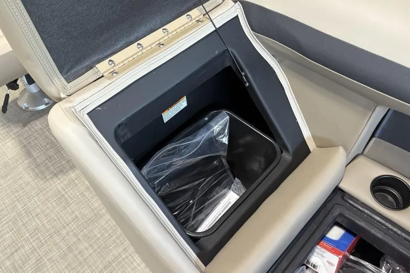 Slide: The Image of Storage compartment in 2026 Premier 220 Sunscape RF boat with cup holder and accessories. - 13