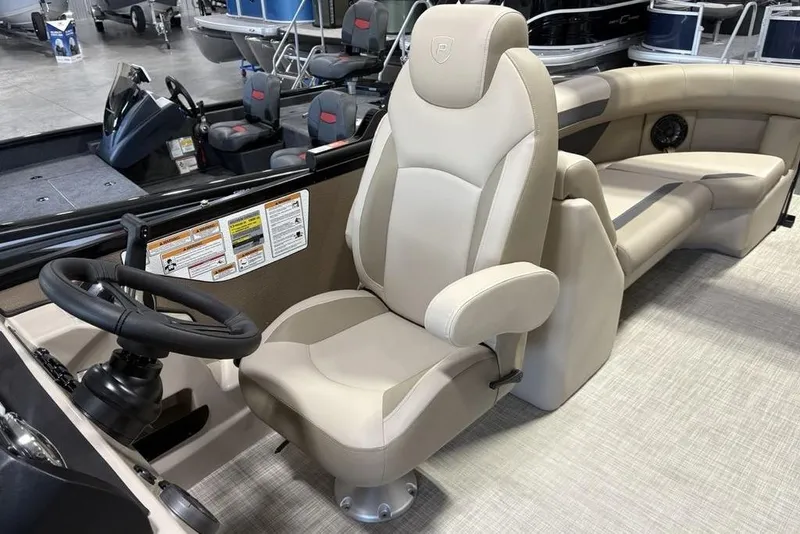 Slide: The Image of 2026 Premier 220 Sunscape RF boat interior with beige captain's chair and steering wheel. - 23