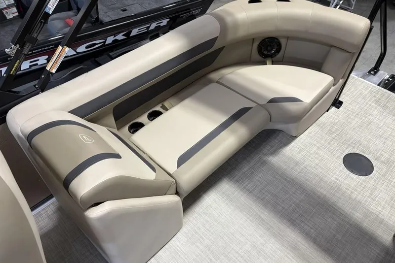 Slide: The Image of Luxurious seating in 2026 Premier 220 Sunscape RF boat, featuring beige upholstery and cup holders. - 24