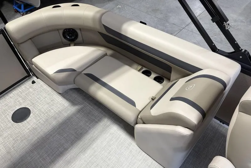 Slide: The Image of Luxurious seating in 2026 Premier 220 Sunscape RF boat, featuring beige upholstery and cup holders. - 26