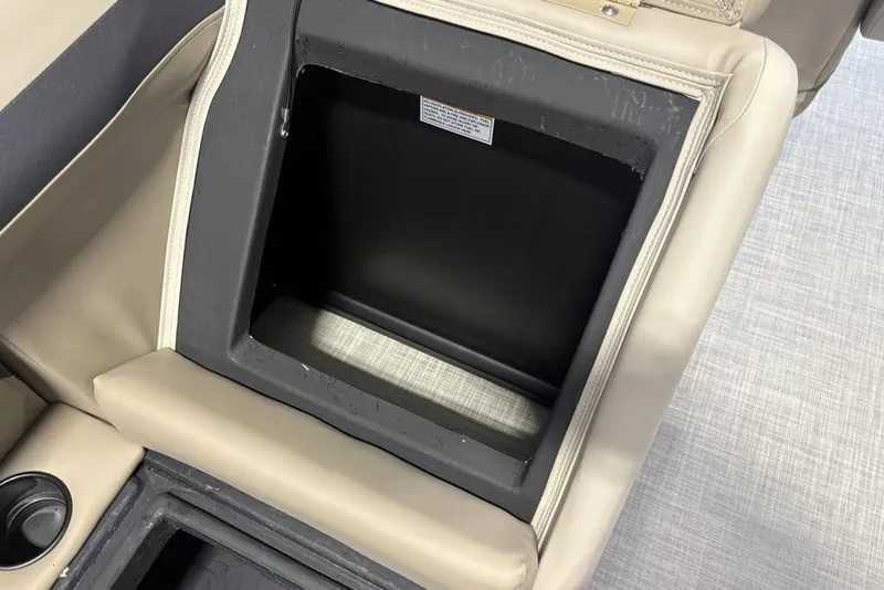 Slide: The Image of Storage compartment in 2026 Premier 220 Sunscape RF boat with beige upholstery. - 27