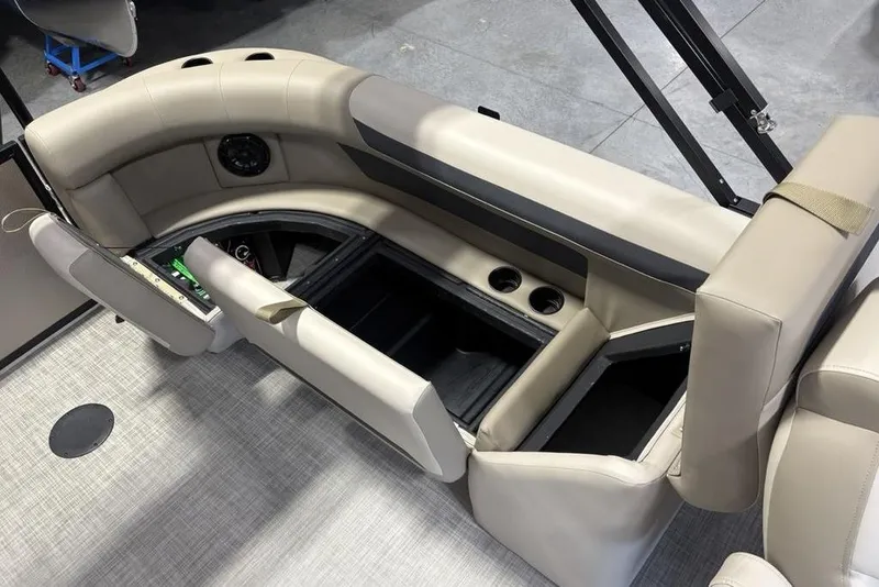 Slide: The Image of 2026 Premier 220 Sunscape RF boat interior with beige seating and storage compartments. - 29