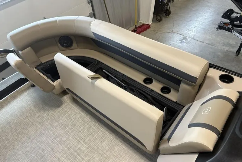 Slide: The Image of 2026 Premier 220 Sunscape RF boat interior with beige seating and cup holders. - 5