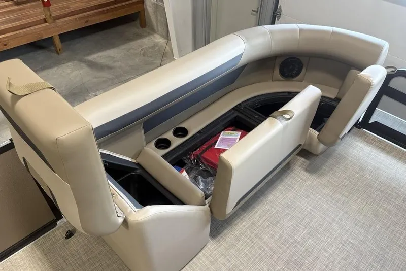 Slide: The Image of 2026 Premier 220 Sunscape RF boat interior with beige seating and storage compartments. - 6