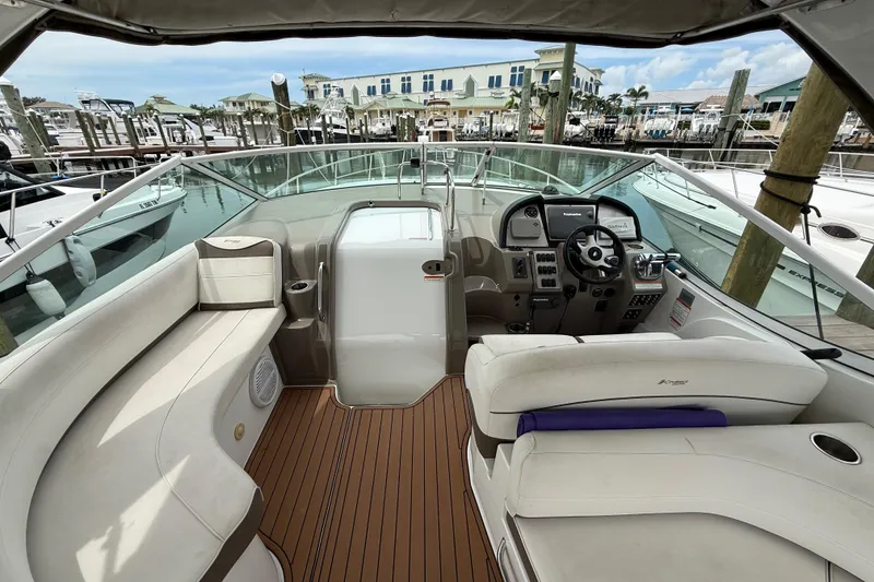 Slide: The Image of 2008 Cruisers Yachts 330 Express cockpit with luxurious seating and modern controls at marina. - 13