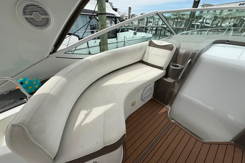 Slide: The Image of 2008 Cruisers Yachts 330 Express interior with curved seating and wood-style flooring. - 14