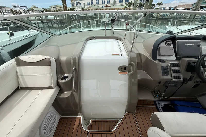 Slide: The Image of 2008 Cruisers Yachts 330 Express cockpit with helm, seating, and control panel. - 15