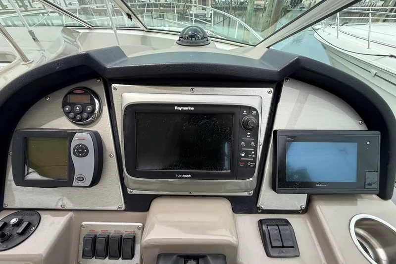Slide: The Image of Dashboard of 2008 Cruisers Yachts 330 Express with navigation and control systems. - 19