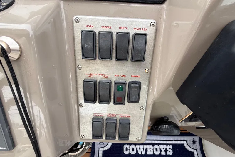 Slide: The Image of Control panel of a 2008 Cruisers Yachts 330 Express with labeled switches. - 21