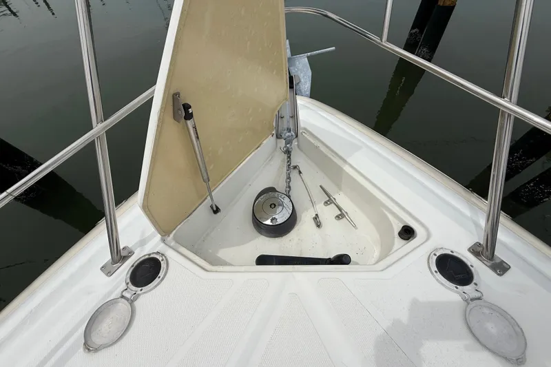 Slide: The Image of 2008 Cruisers Yachts 330 Express anchor locker with open hatch and visible chain. - 30