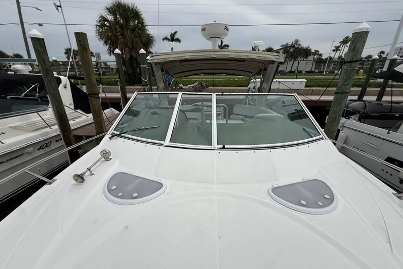 Slide: The Image of 2008 Cruisers Yachts 330 Express docked, featuring sleek design and spacious deck. - 32