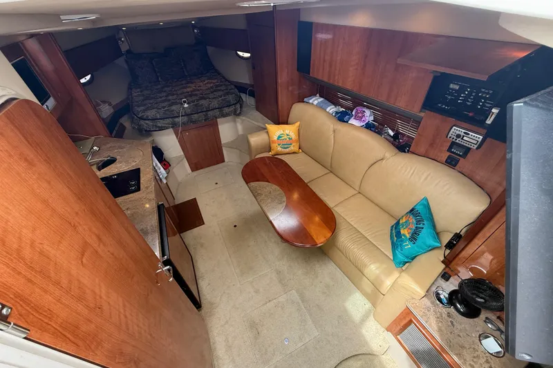 Slide: The Image of Luxurious 2008 Cruisers Yachts 330 Express cabin interior with cozy seating and elegant wood finishes. - 38