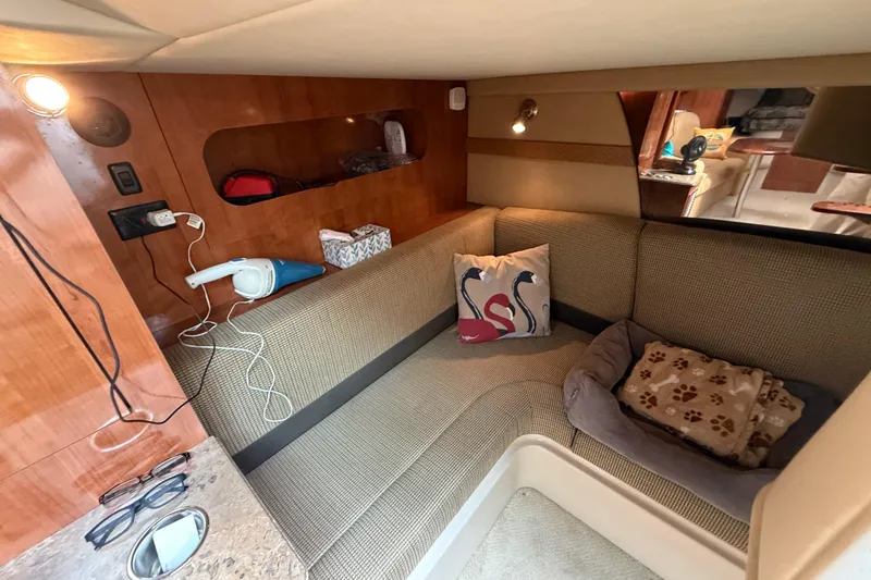 Slide: The Image of 2008 Cruisers Yachts 330 Express cabin interior with cozy seating and decorative pillows. - 43
