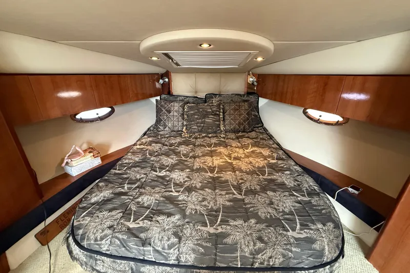 Slide: The Image of Luxurious cabin interior of 2008 Cruisers Yachts 330 Express with cozy bedding and wood accents. - 45
