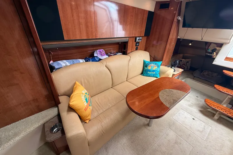 Slide: The Image of Interior of 2008 Cruisers Yachts 330 Express with beige sofa and wooden table. - 51