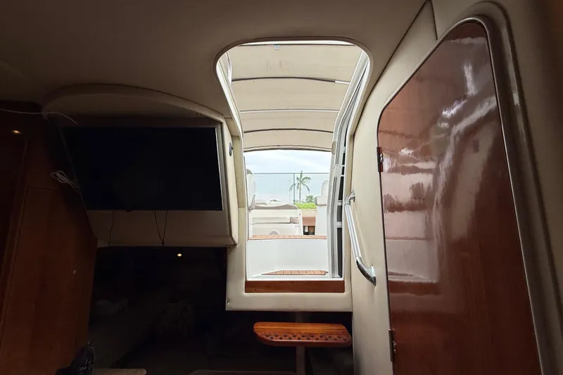 Slide: The Image of Interior view of 2008 Cruisers Yachts 330 Express, featuring cabin entrance and wooden finishes. - 52