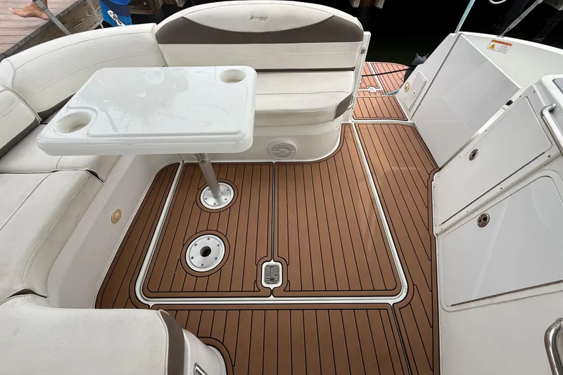 Slide: The Image of 2008 Cruisers Yachts 330 Express interior with seating and table on teak-style flooring. - 59