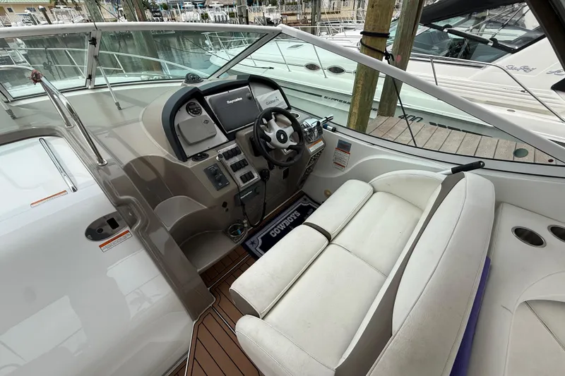 Slide: The Image of 2008 Cruisers Yachts 330 Express cockpit with steering wheel and seating area. - 16