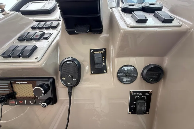 Slide: The Image of 2008 Cruisers Yachts 330 Express control panel with Raymarine equipment and switches. - 24
