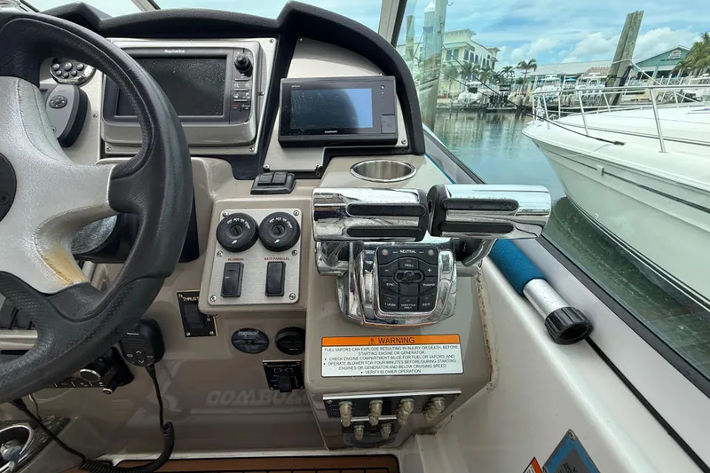 Slide: The Image of 2008 Cruisers Yachts 330 Express helm with steering wheel and control panel. - 25
