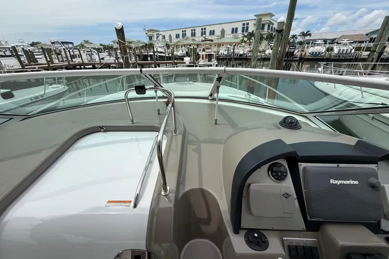 Slide: The Image of 2008 Cruisers Yachts 330 Express helm with Raymarine navigation, docked at marina. - 27