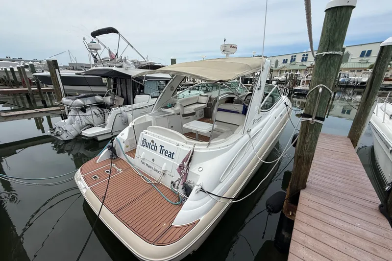 Slide: The Image of 2008 Cruisers Yachts 330 Express docked at marina, featuring spacious deck and canopy. - 3