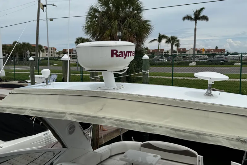 Slide: The Image of 2008 Cruisers Yachts 330 Express with Raymarine radar, docked near palm trees. - 34