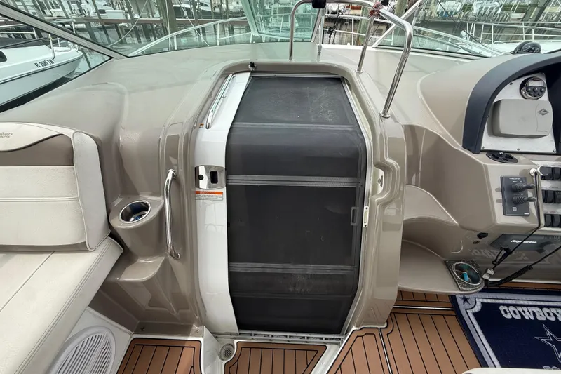 Slide: The Image of 2008 Cruisers Yachts 330 Express cockpit with helm, seating, and control panel. - 36