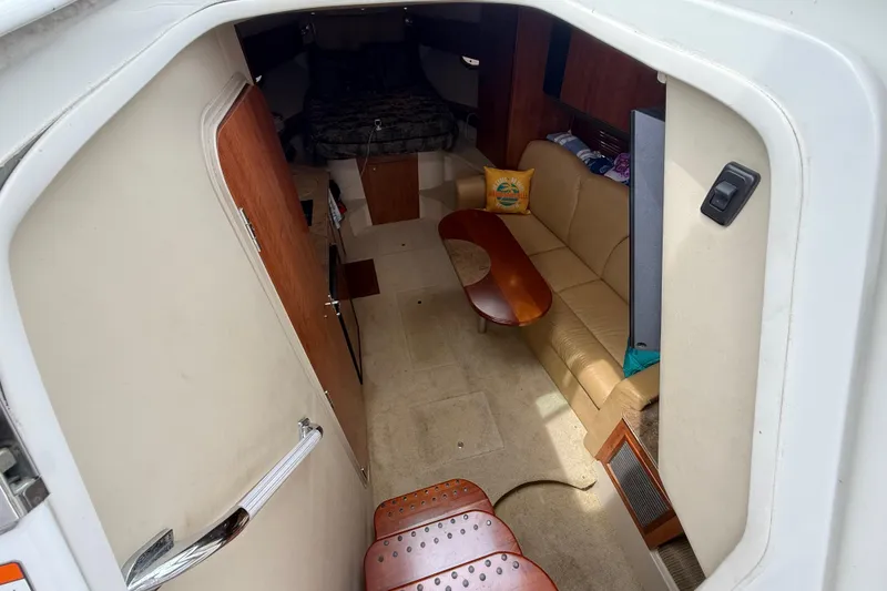 Slide: The Image of Interior view of 2008 Cruisers Yachts 330 Express, featuring cozy seating and wooden accents. - 37