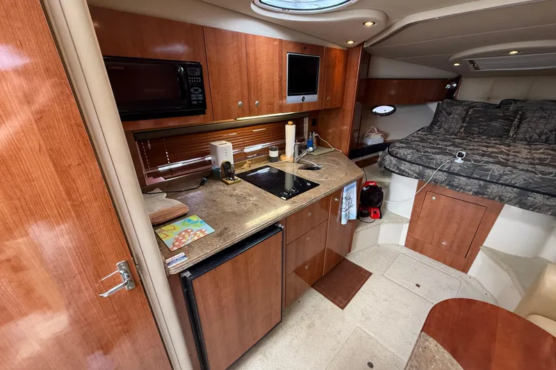 Slide: The Image of 2008 Cruisers Yachts 330 Express interior with kitchenette and cozy sleeping area. - 40