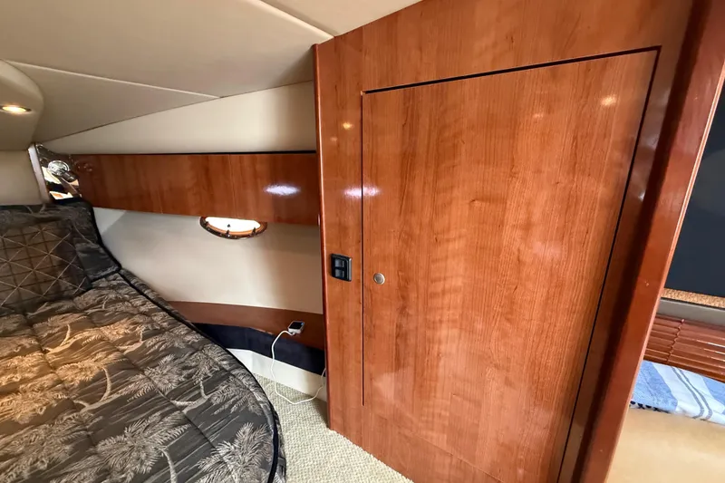 Slide: The Image of 2008 Cruisers Yachts 330 Express cabin interior with wood paneling and bed. - 46