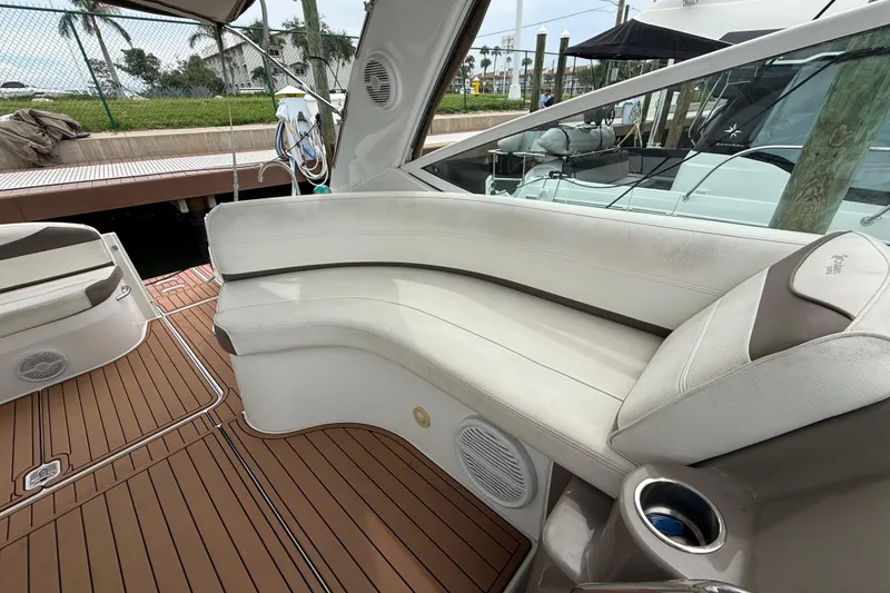 Slide: The Image of 2008 Cruisers Yachts 330 Express interior with white seating and wood flooring. - 53