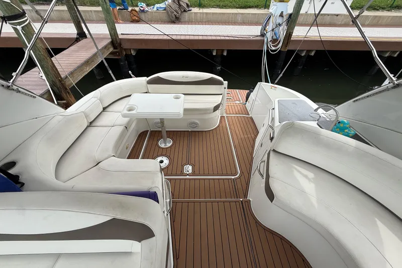 Slide: The Image of 2008 Cruisers Yachts 330 Express interior with white seating and wooden deck. - 55