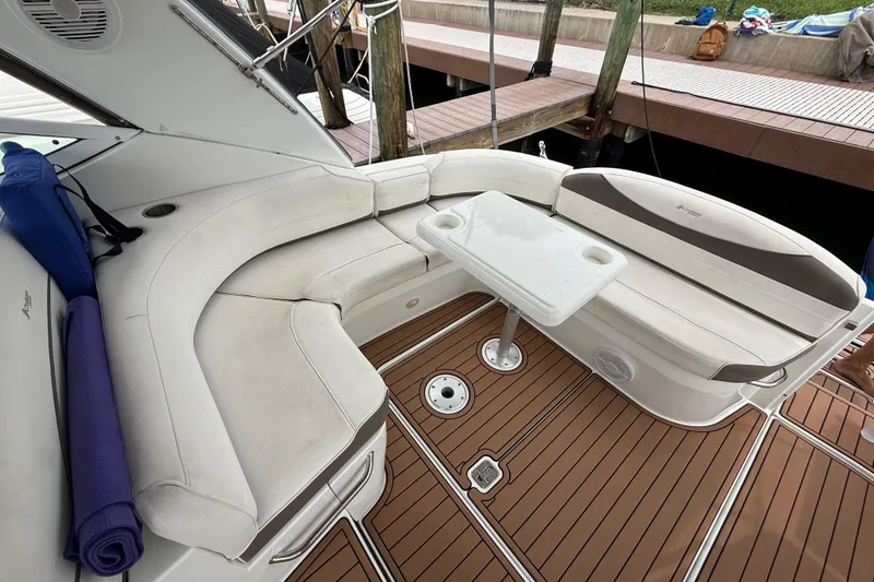 Slide: The Image of 2008 Cruisers Yachts 330 Express boat with white seating and wooden deck. - 57