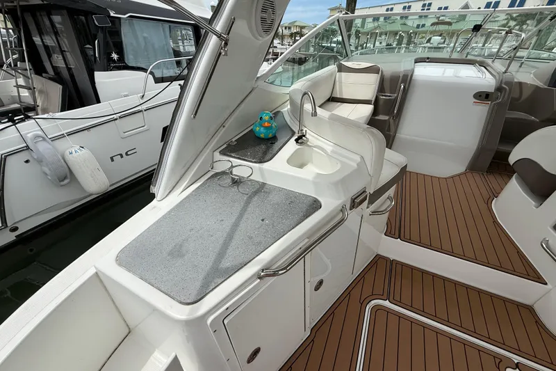 Slide: The Image of 2008 Cruisers Yachts 330 Express interior with sink and seating area. - 9