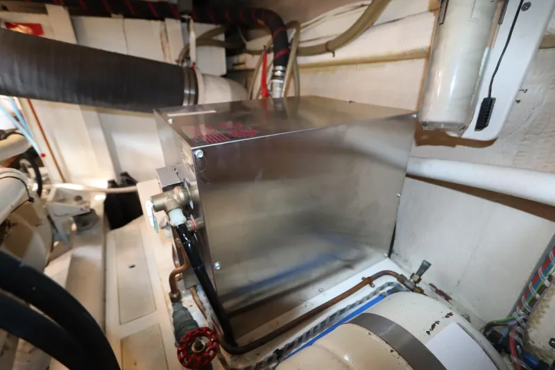 Slide: The Image of Engine room of 1993 Grand Banks 46 Classic yacht, featuring mechanical equipment. - 105