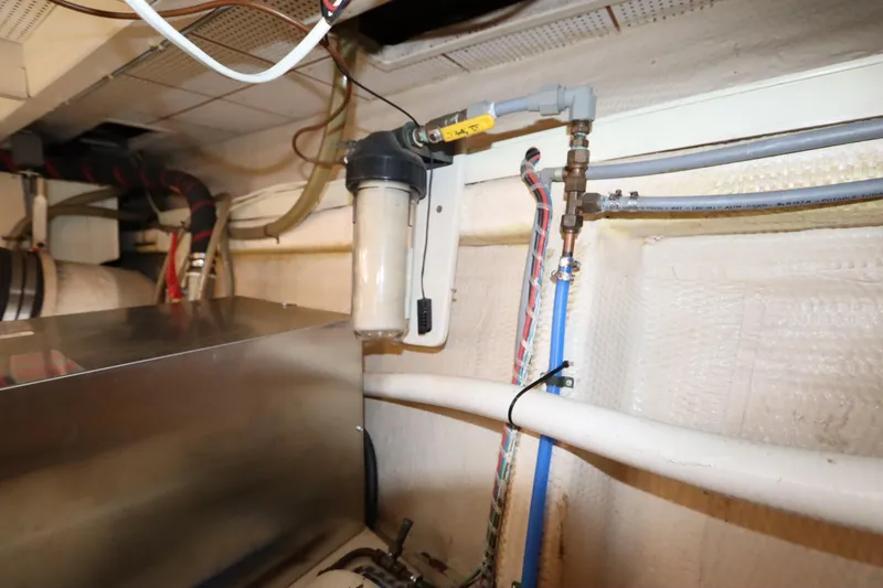 Slide: The Image of Engine room of 1993 Grand Banks 46 Classic yacht, showing fuel filter and piping system. - 106