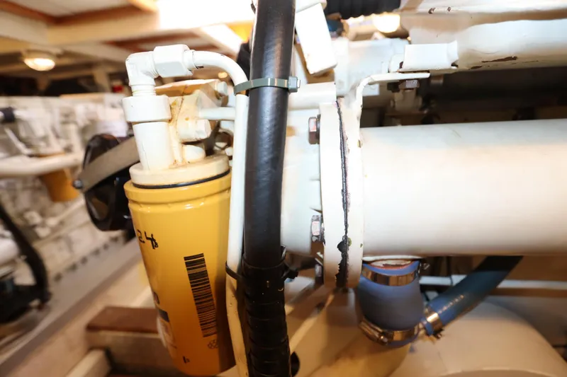 Slide: The Image of Engine room of 1993 Grand Banks 46 Classic yacht, showing mechanical components and piping. - 108